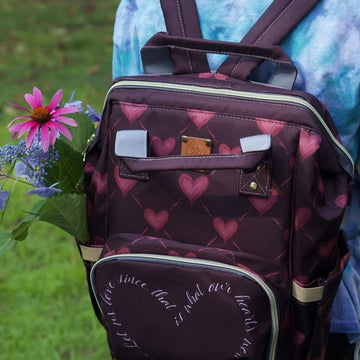 Catholic diaper bag featuring hearts and St. Therese's Let Us Love quote