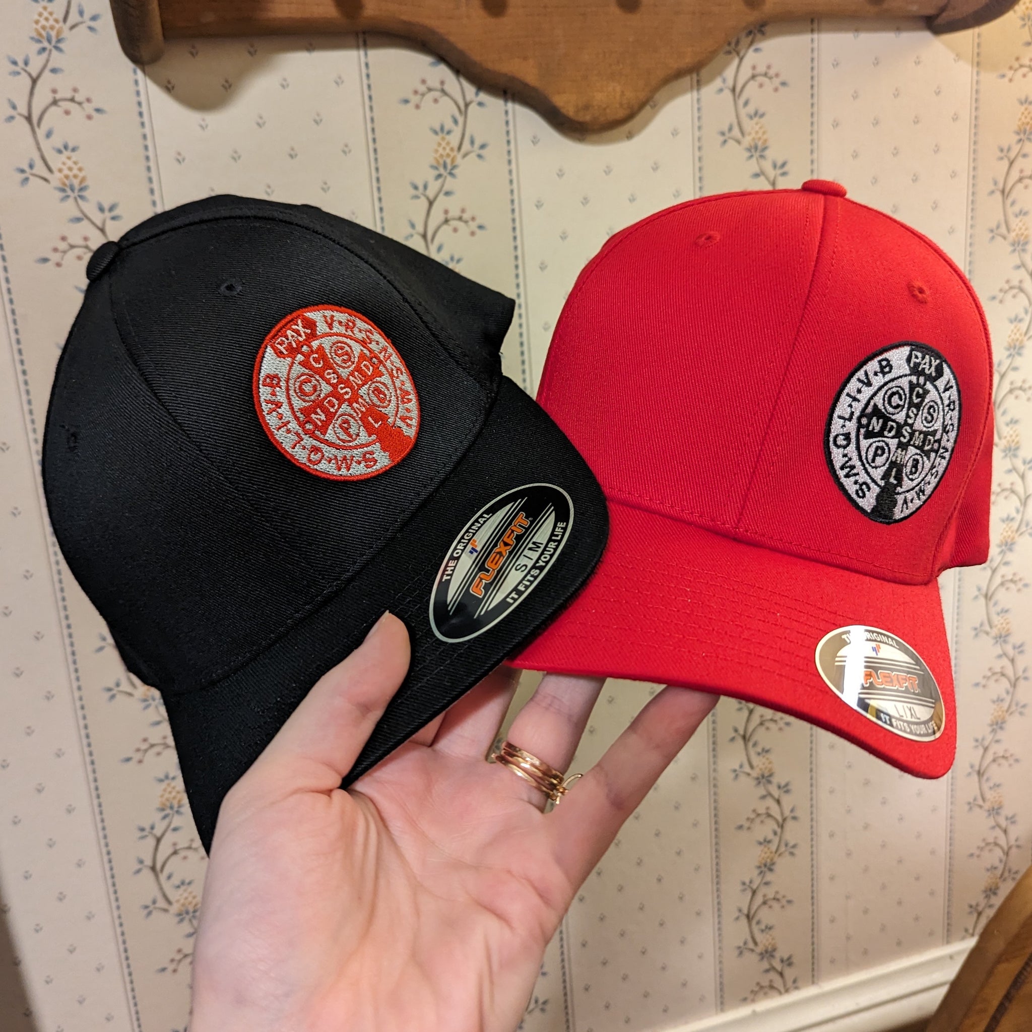 St. Benedict Medal baseball hats in black and red