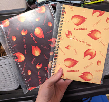 Two spiral notebooks, or journals, featuring a flame design and the Gifts of the Holy Spirit.